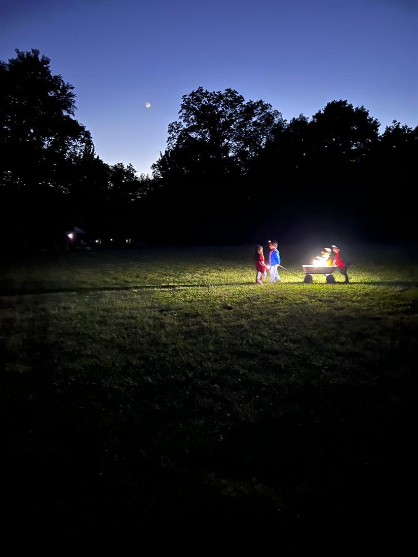 Scouts with a campfire wagon at dusk